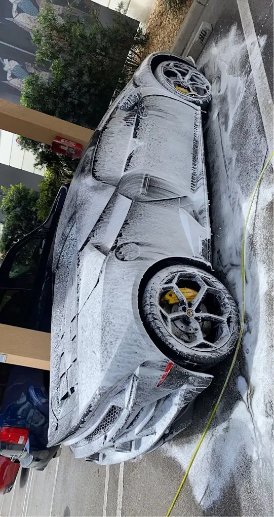 Lamborghini side profile during foam wash treatment