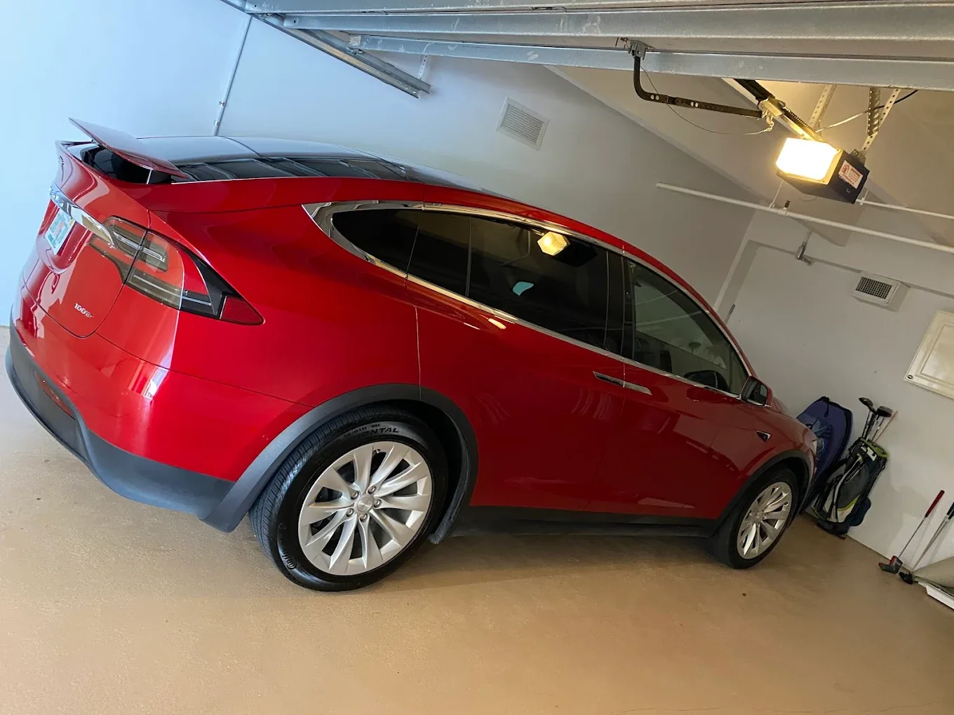 Red Tesla Model X exterior detail in garage